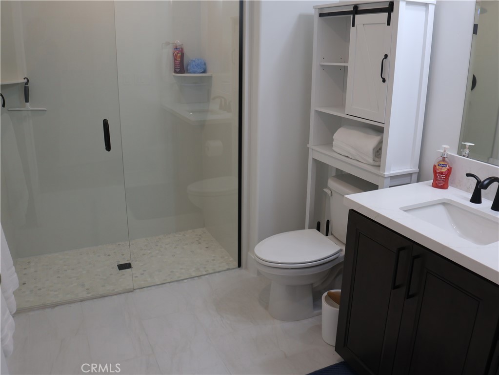 402 West Grand Avenue, Unit 302 Grover Beach, CA 93433 - Photo 7 of 10 a bathroom with a sink and a mirror