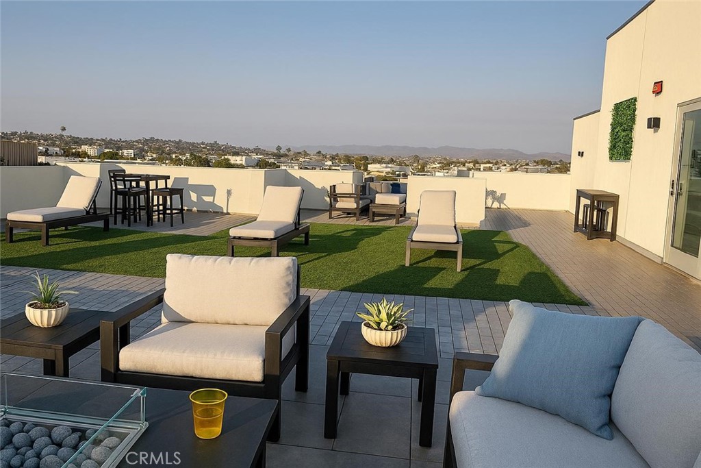 402 West Grand Avenue, Unit 302 Grover Beach, CA 93433 - Photo 8 of 10 a view of a terrace with couches and a table and chairs
