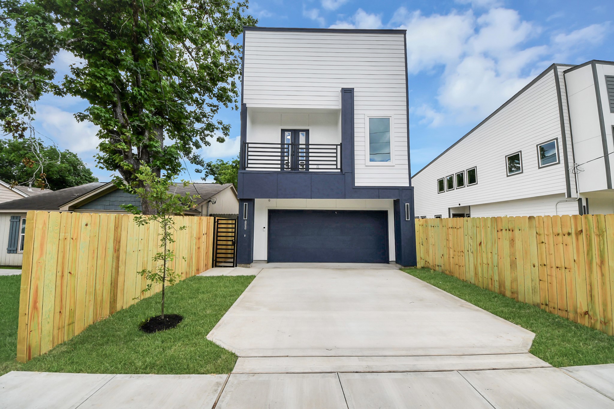 Striking contemporary exterior with clean architectural lines and a private driveway.