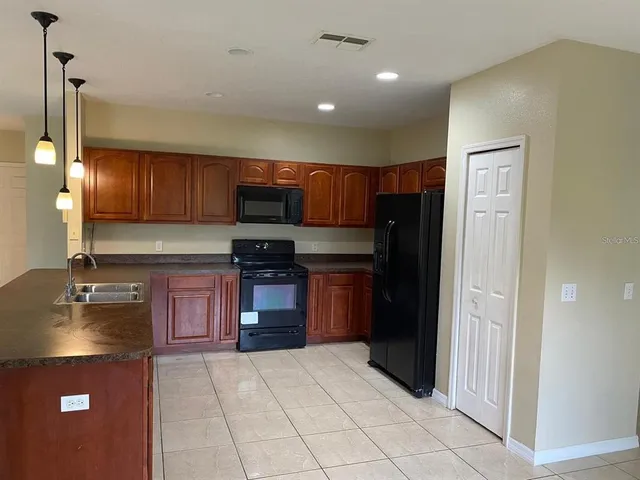 a kitchen with a refrigerator and a sink