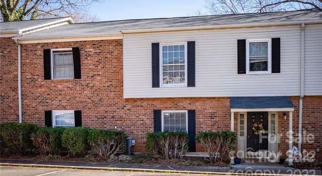 5931 Quail Hollow Road, Unit G Charlotte, NC 28210 - Photo 1 of 7 a front view of a house with plants