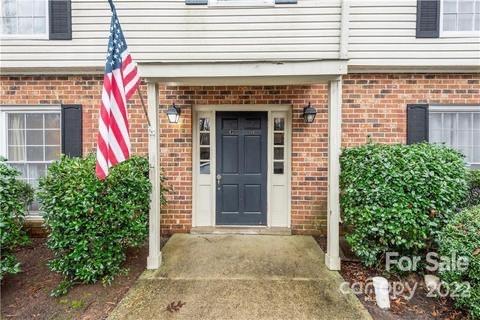 5931 Quail Hollow Road, Unit G Charlotte, NC 28210 - Photo 2 of 7 a front view of a house with plants