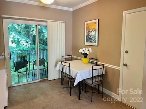 5931 Quail Hollow Road, Unit G Charlotte, NC 28210 - Photo 6 of 7 a dining room with furniture and a floor to ceiling window