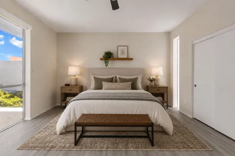 a bedroom with a bed and a chandelier