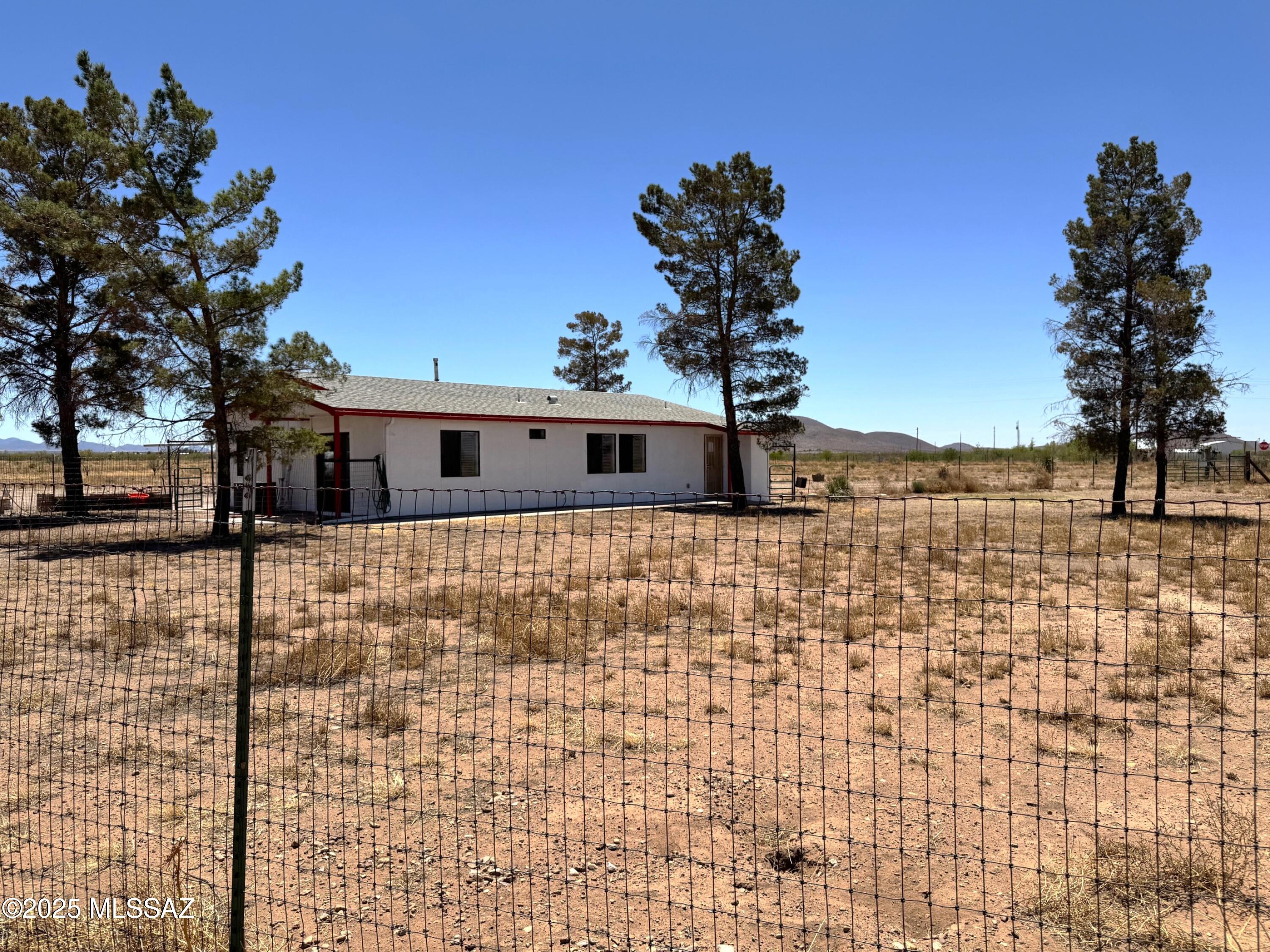 13384 South Cottonwood Road Pearce, AZ 85625 - Photo 6 of 46 a front view of a house with a yard