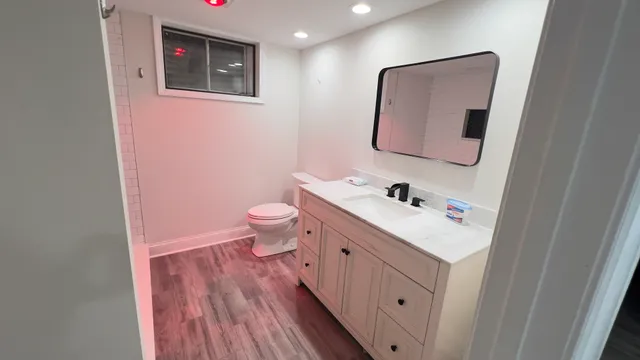 a bathroom with a sink vanity and mirror