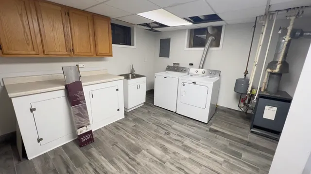 a utility room with cabinets washer and dryer