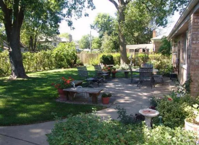 a backyard of a house with a yard and outdoor seating