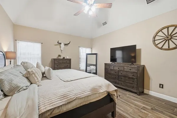 a bedroom with a bed and a flat screen tv
