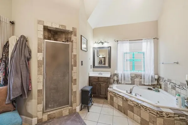 a spacious bathroom with a bathtub and a sink