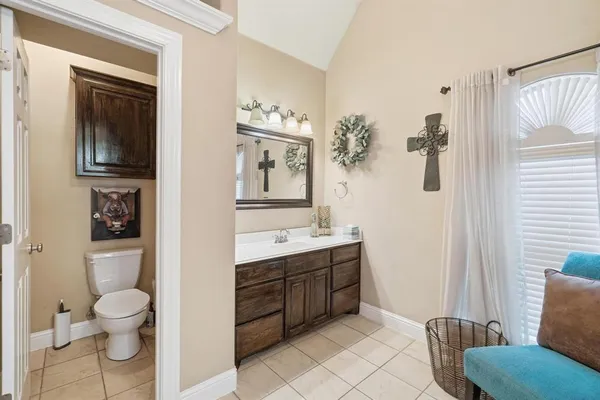 a bathroom with a toilet sink and mirror