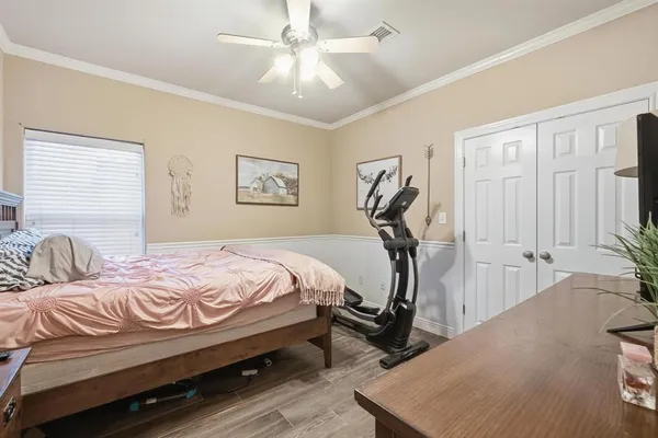 a bedroom with a bed and ceiling fan