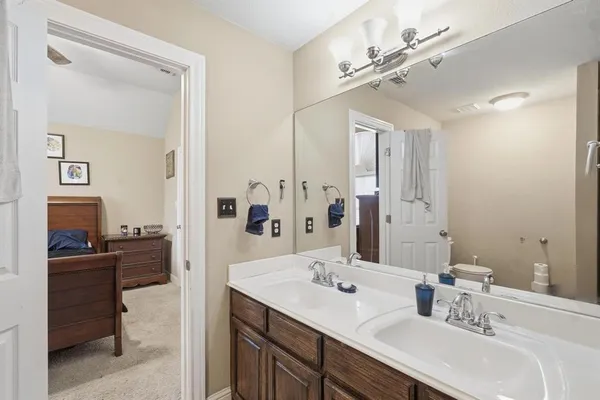 a en suite bathroom with a double vanity sink double mirror and a