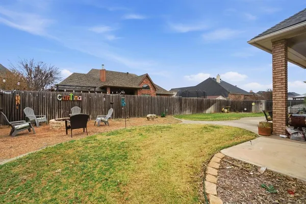 a view of a house with a yard patio and sitting area