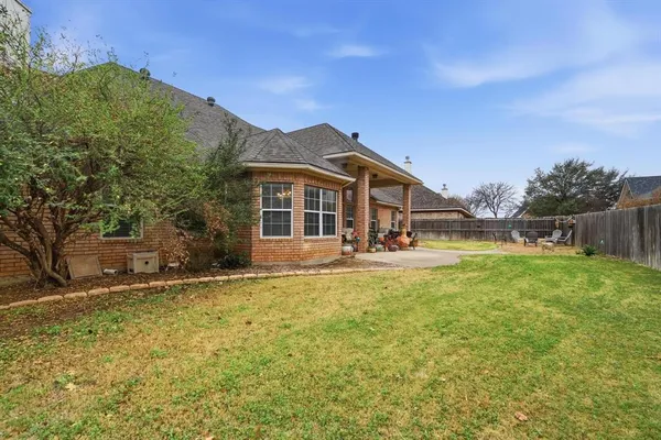 a view of a backyard with a garden and fire pit