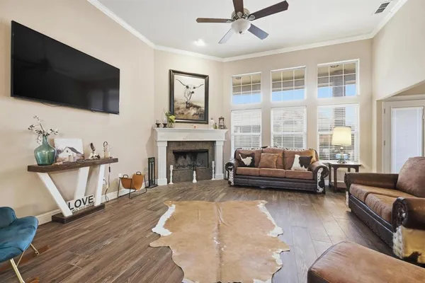 a living room with furniture a flat screen tv and a fireplace