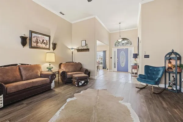 a living room with furniture and wooden floor