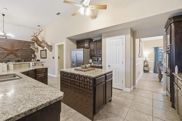 a kitchen with a sink a counter top space and stainless steel appliances