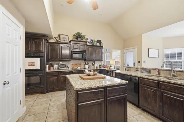a kitchen with a sink stove and refrigerator
