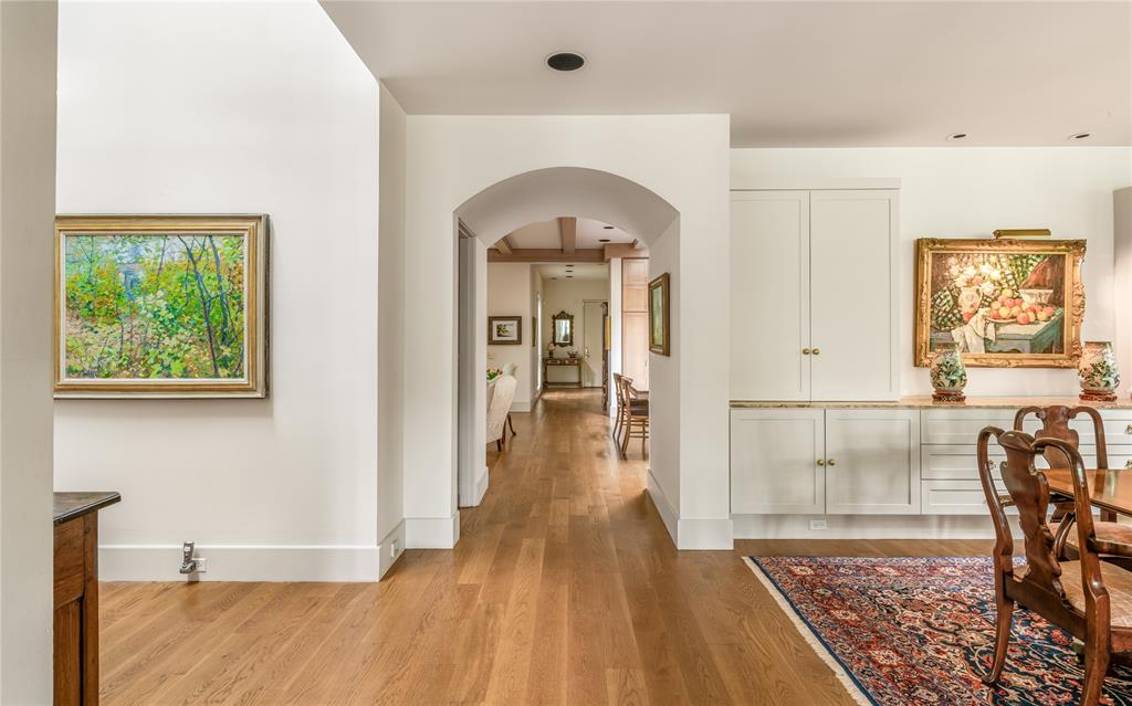12102 Vendome Place Dallas, TX 75230 - Photo 11 of 24 a view of a hallway view with wooden floor and staircase
