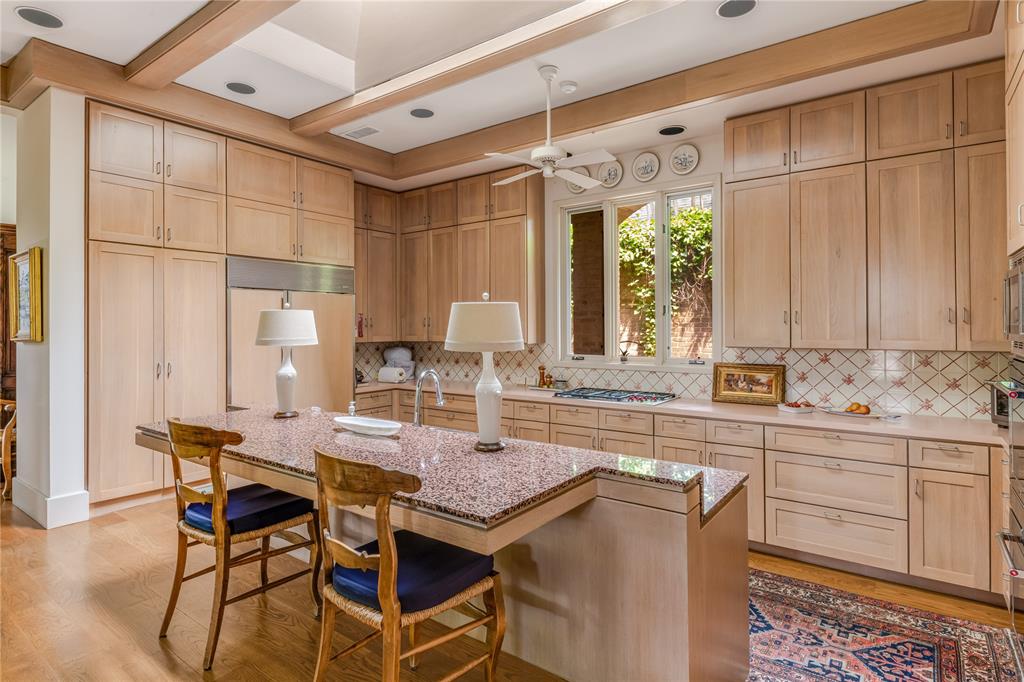 12102 Vendome Place Dallas, TX 75230 - Photo 12 of 24 a kitchen with a table chairs sink and cabinets