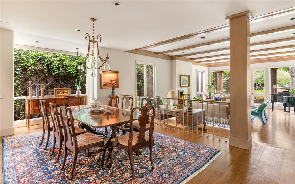 12102 Vendome Place Dallas, TX 75230 - Photo 5 of 24 a view of a dining room and livingroom with furniture wooden floor a chandelier