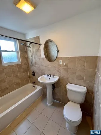 a bathroom with a toilet a sink and bathtub