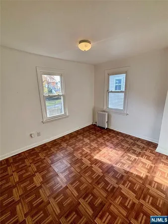 a view of a bedroom with a bed and a window