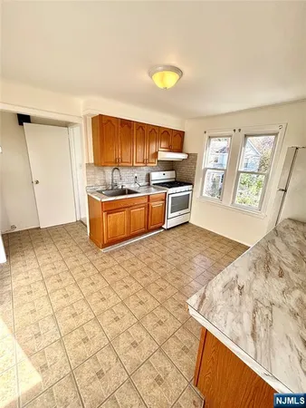 a view of kitchen with wooden cabinets