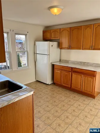 a kitchen with a refrigerator sink and cabinets