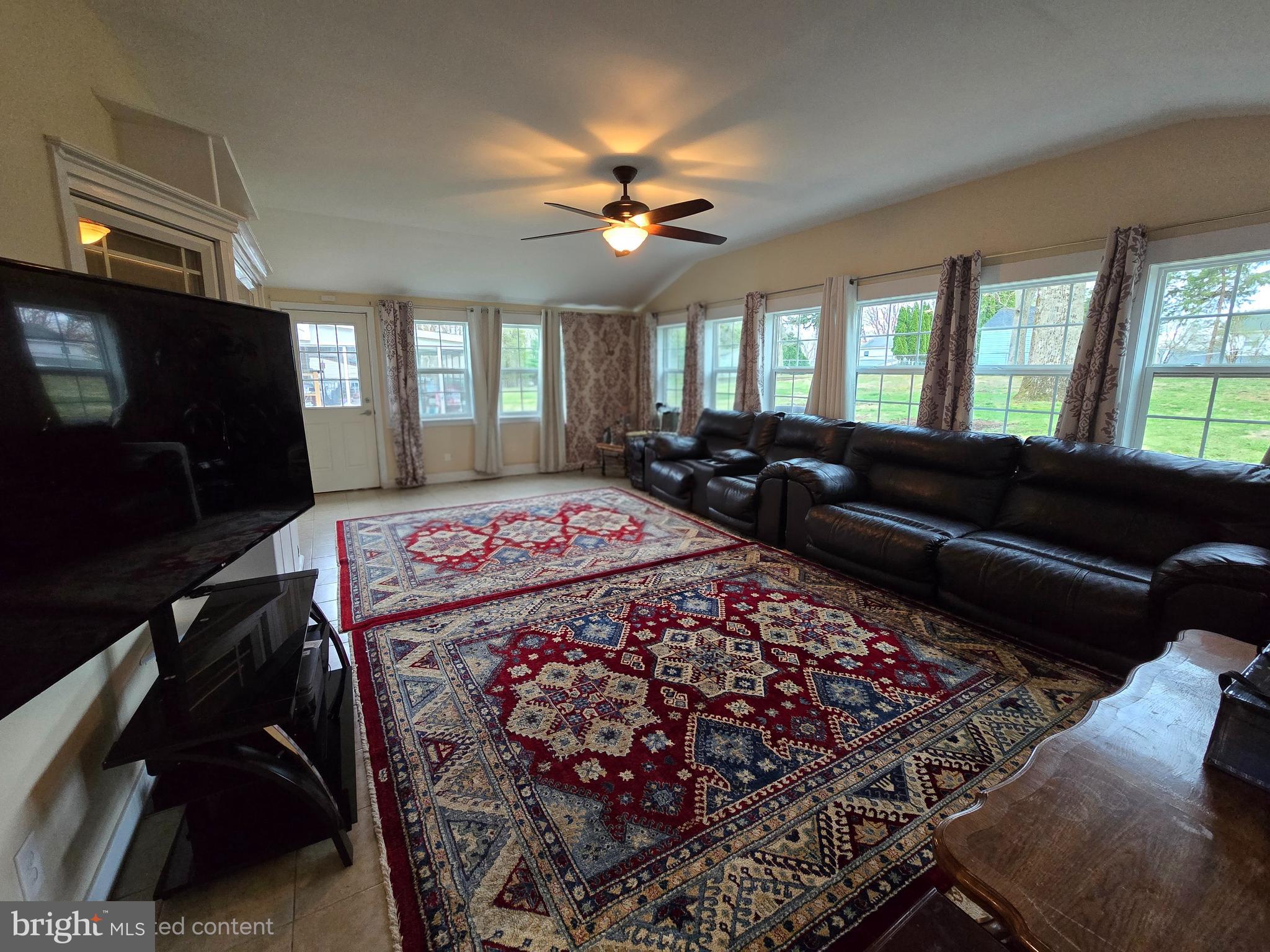 743 Bridgeview Road Feasterville-Trevose, PA 19053 - Photo 17 of 55 a living room with a couch a fireplace and a flat screen tv