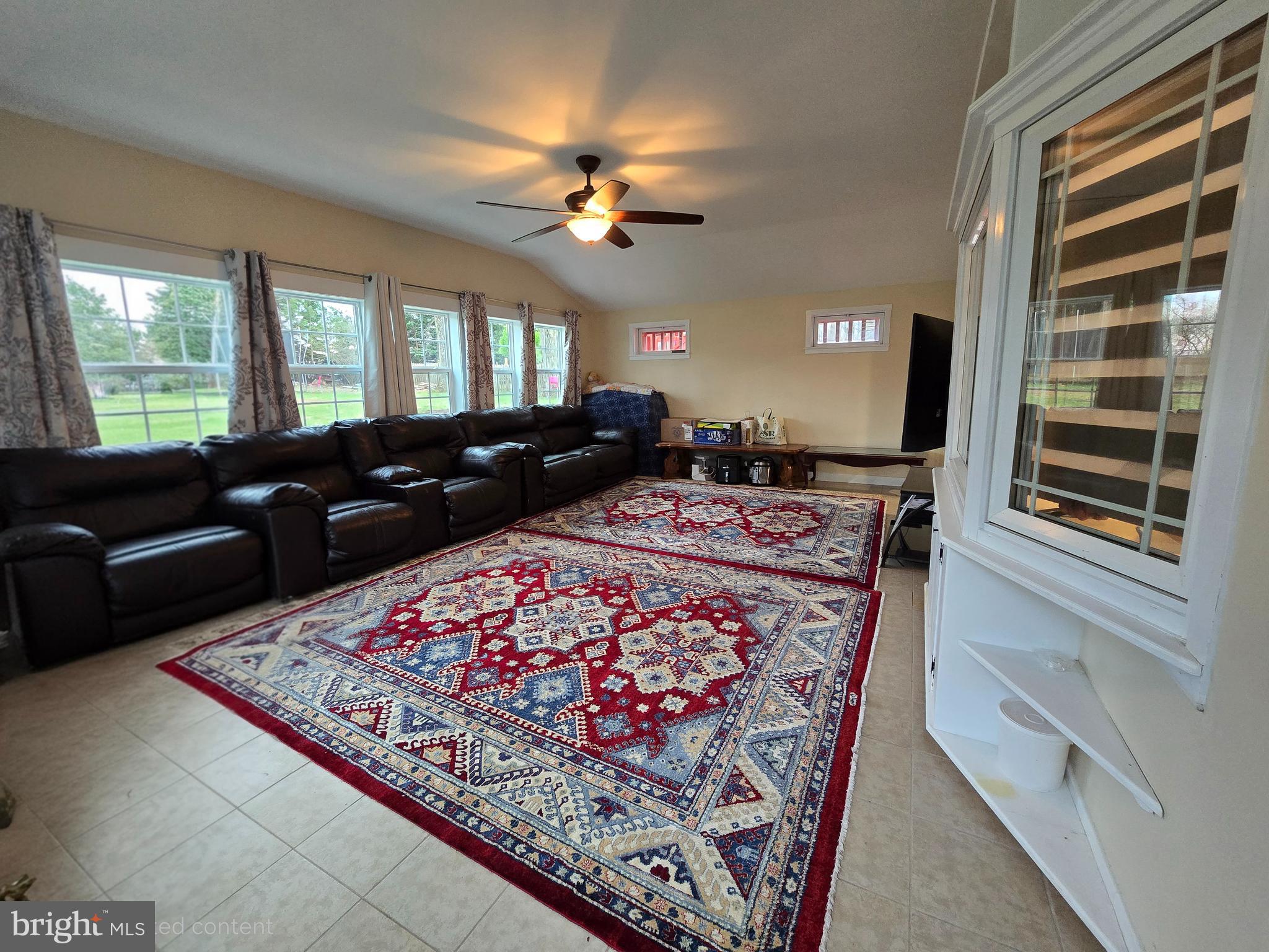 743 Bridgeview Road Feasterville-Trevose, PA 19053 - Photo 19 of 55 a living room with furniture a chandelier and a rug