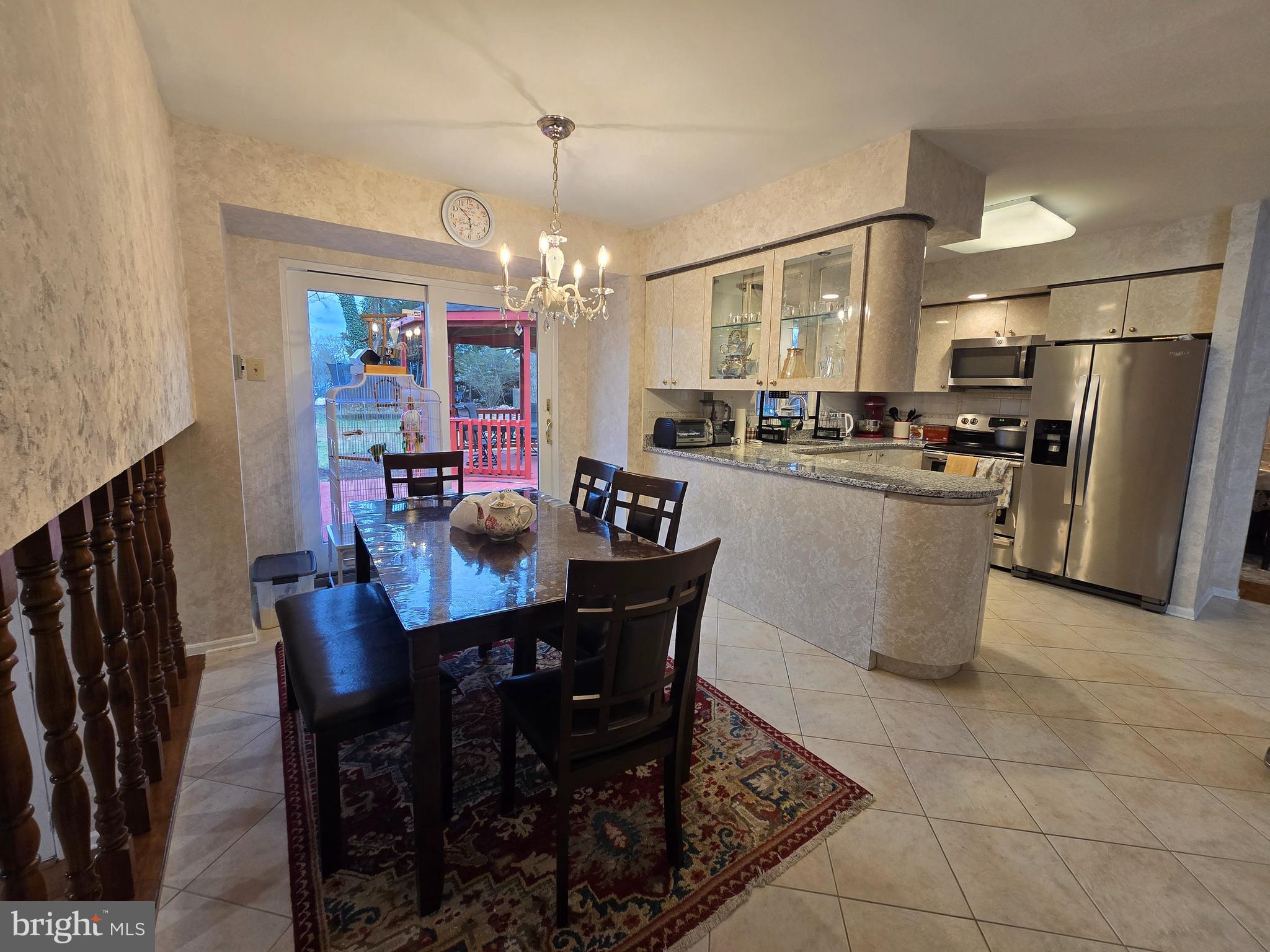 743 Bridgeview Road Feasterville-Trevose, PA 19053 - Photo 9 of 55 a kitchen with refrigerator dining table and chairs