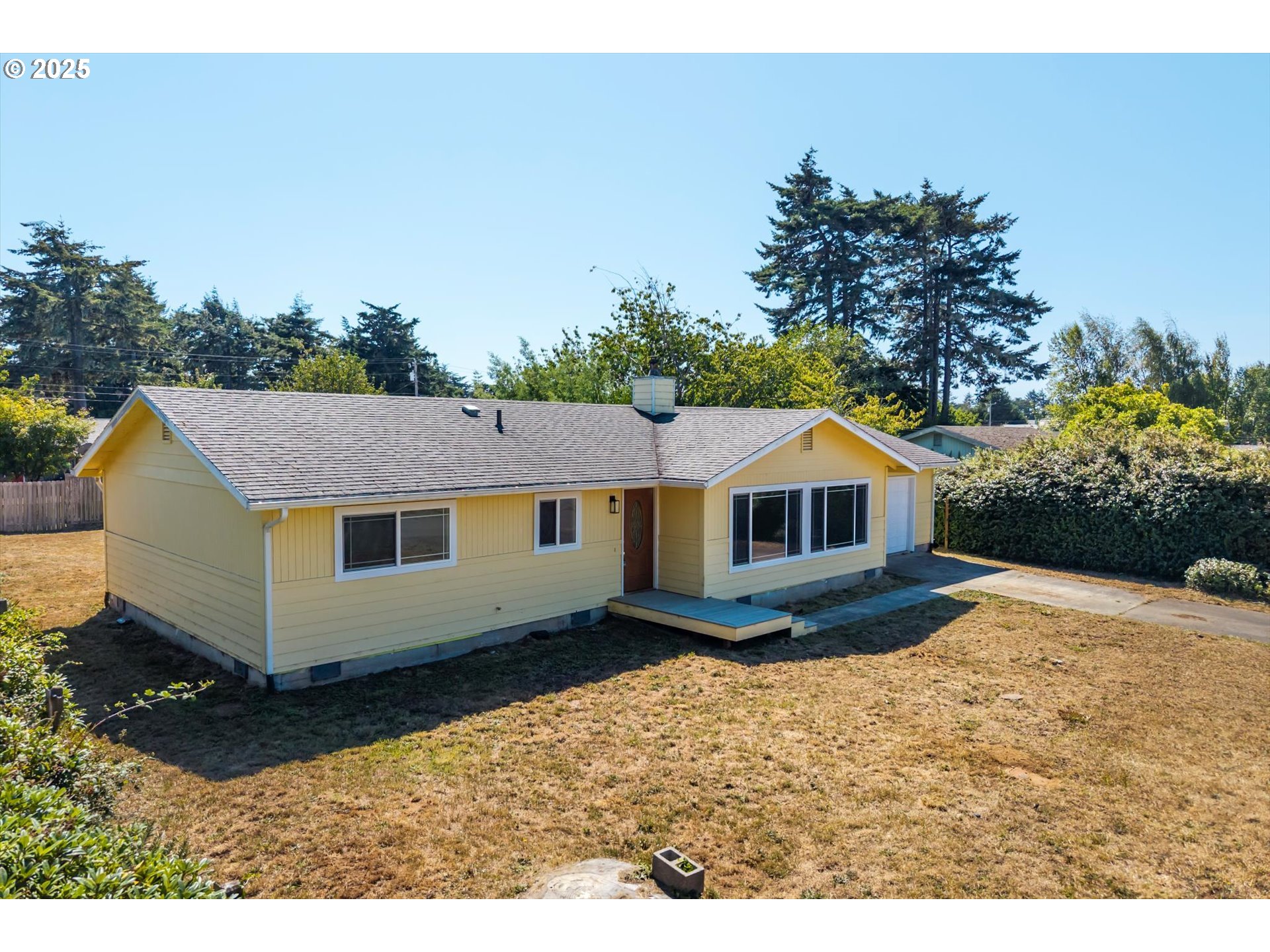 950 1st Street Northeast Bandon, OR 97411 - Photo 2 of 35 a view of house with a yard
