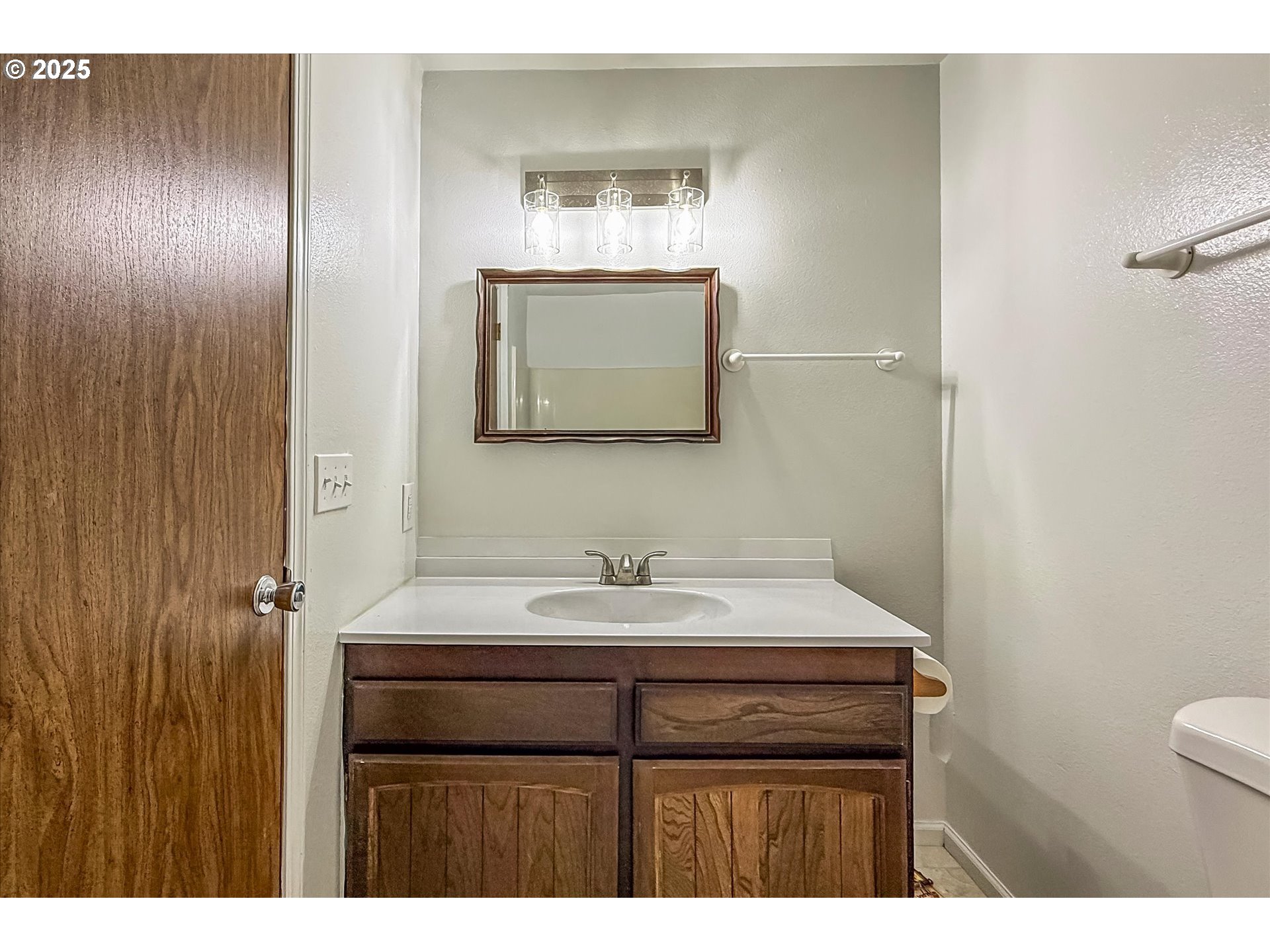 950 1st Street Northeast Bandon, OR 97411 - Photo 23 of 35 a bathroom with a sink and a mirror