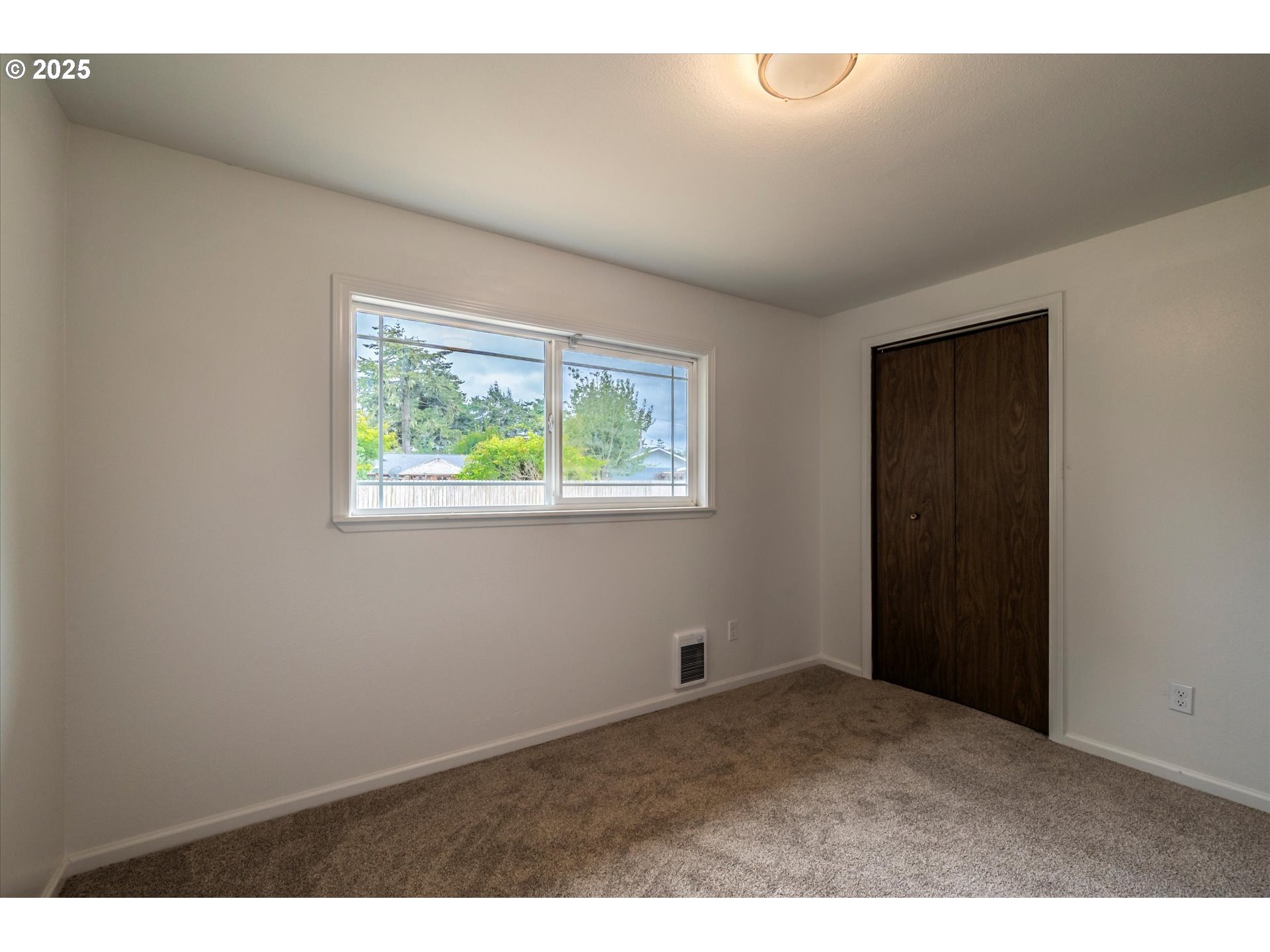 950 1st Street Northeast Bandon, OR 97411 - Photo 30 of 35 a view of an empty room with a window