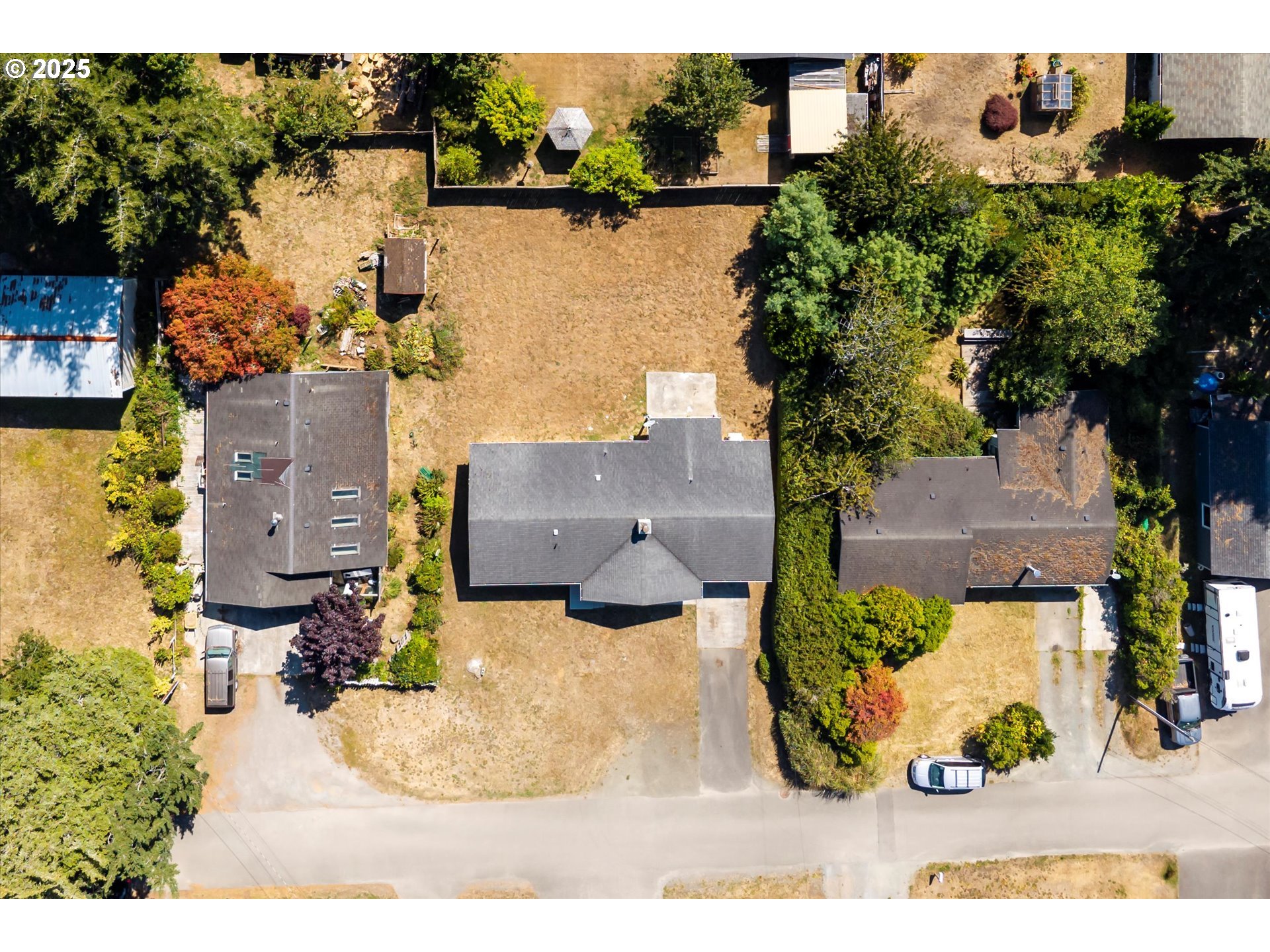 950 1st Street Northeast Bandon, OR 97411 - Photo 4 of 35 an aerial view of houses with yard