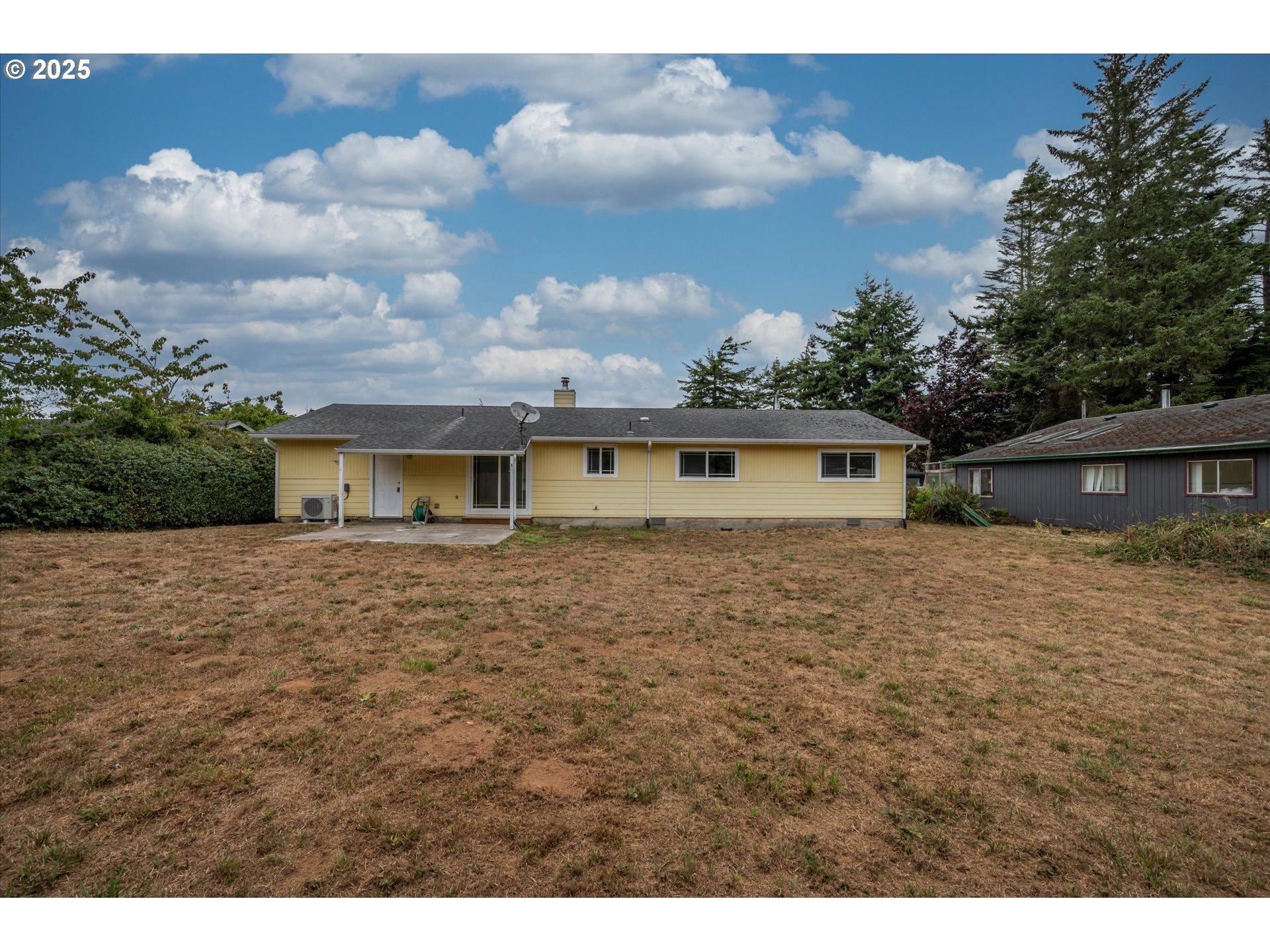 950 1st Street Northeast Bandon, OR 97411 - Photo 5 of 35 a front view of a house with a yard