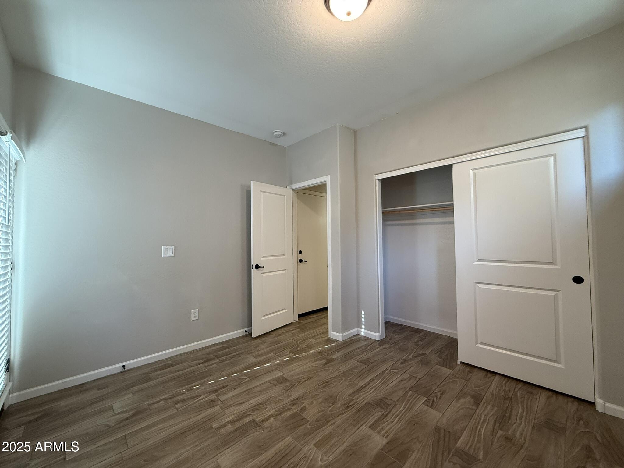 1736 West Pollack Street Phoenix, AZ 85041 - Photo 17 of 51 a view of an empty room with closet and a window