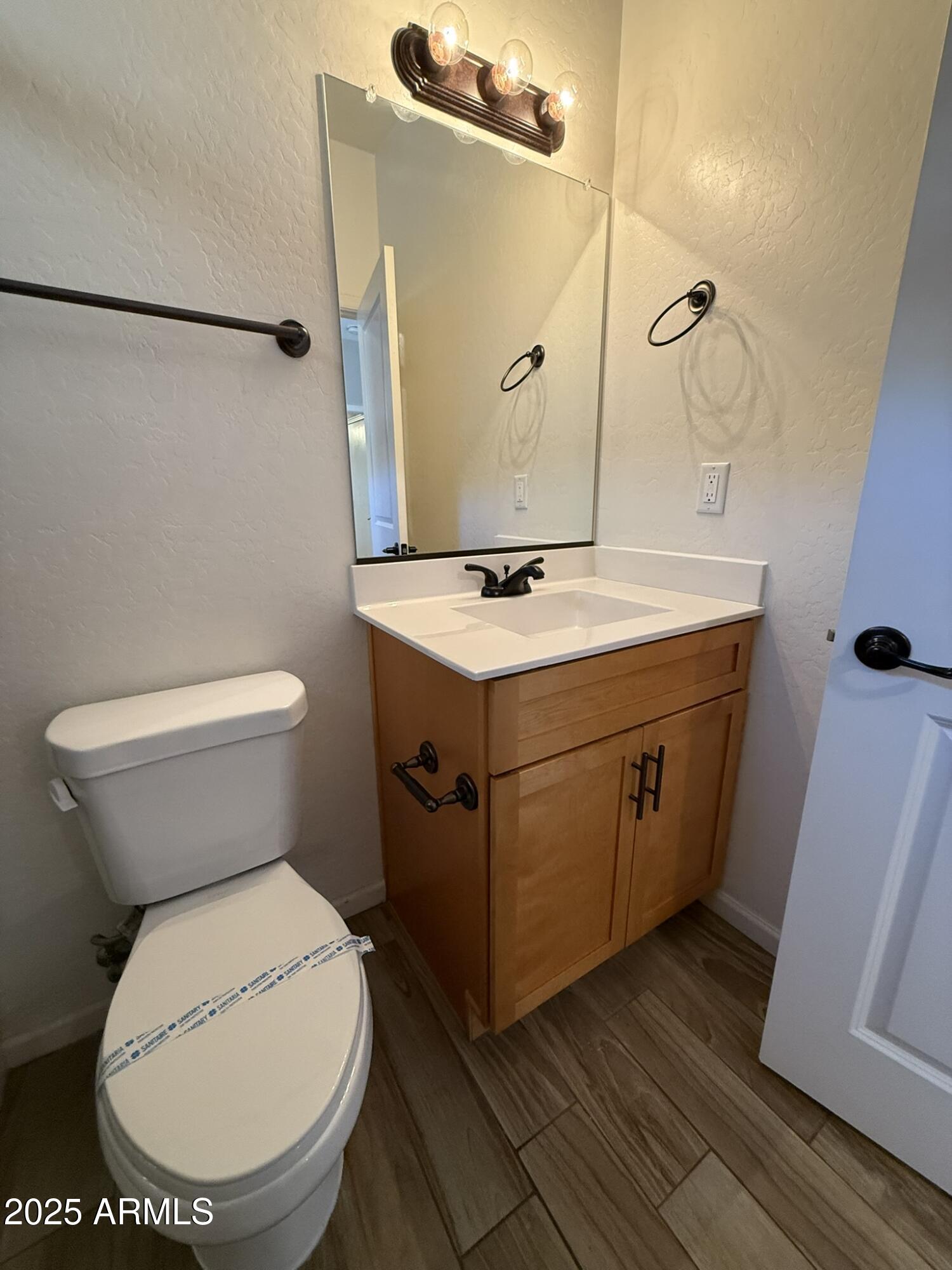1736 West Pollack Street Phoenix, AZ 85041 - Photo 20 of 51 a bathroom with a toilet sink and mirror