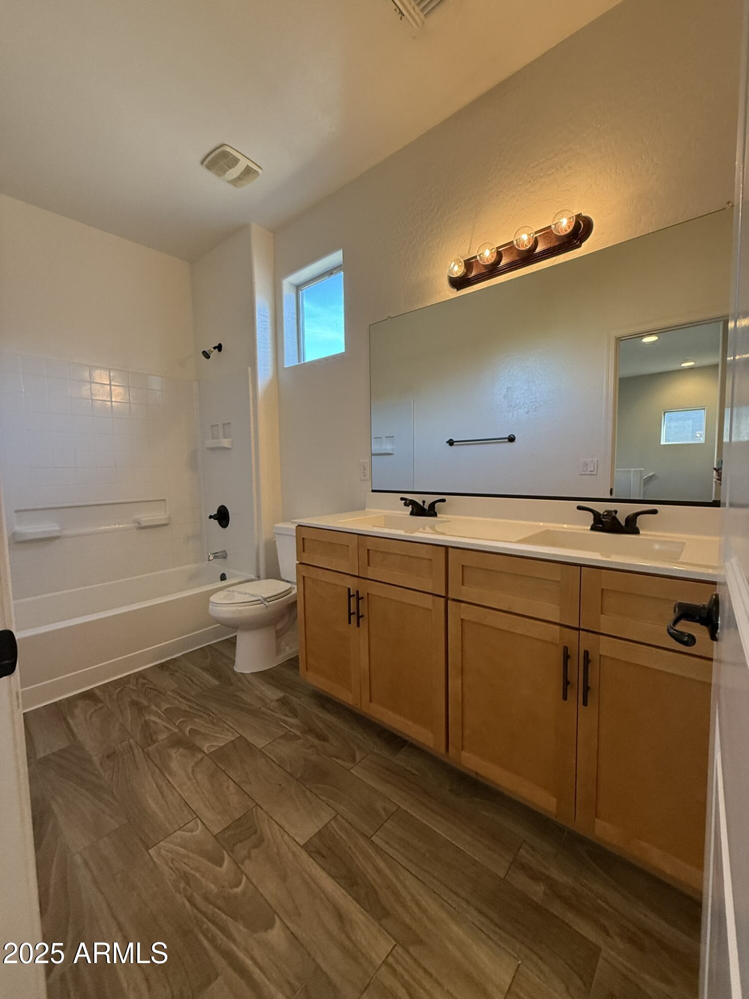 1736 West Pollack Street Phoenix, AZ 85041 - Photo 29 of 51 a bathroom with a sink mirror and toilet