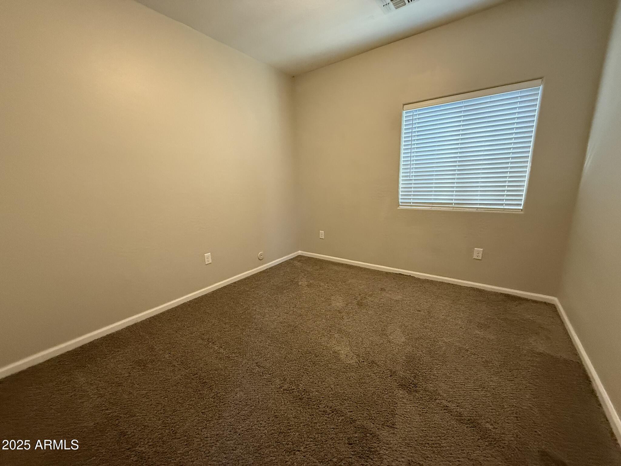1736 West Pollack Street Phoenix, AZ 85041 - Photo 32 of 51 an empty room with a window