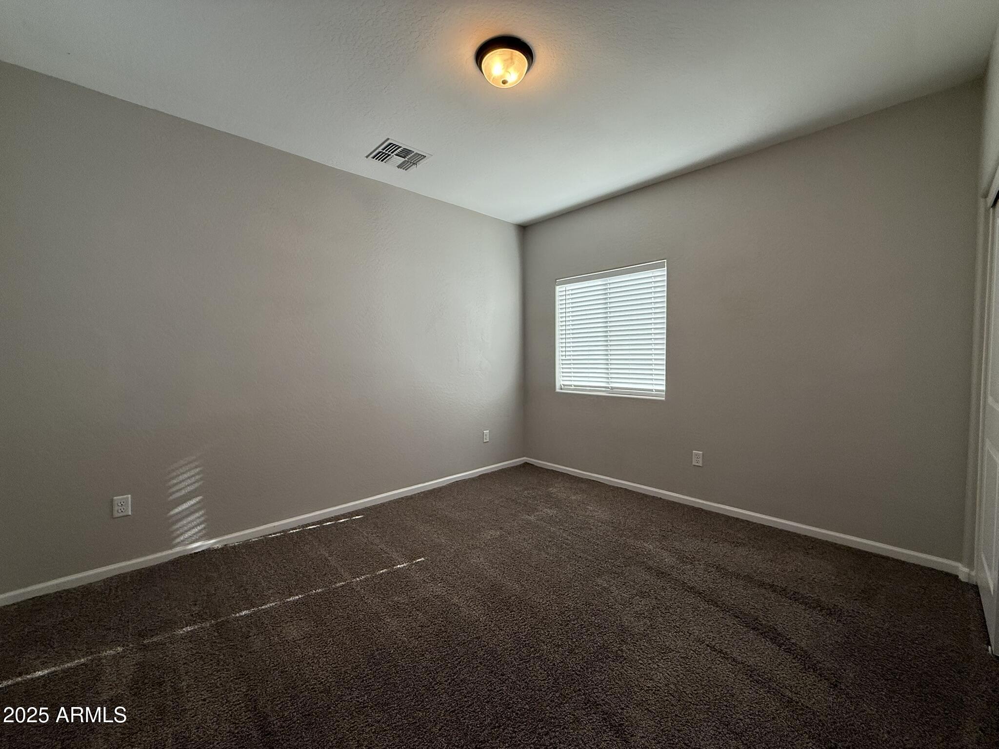 1736 West Pollack Street Phoenix, AZ 85041 - Photo 34 of 51 an empty room with a window