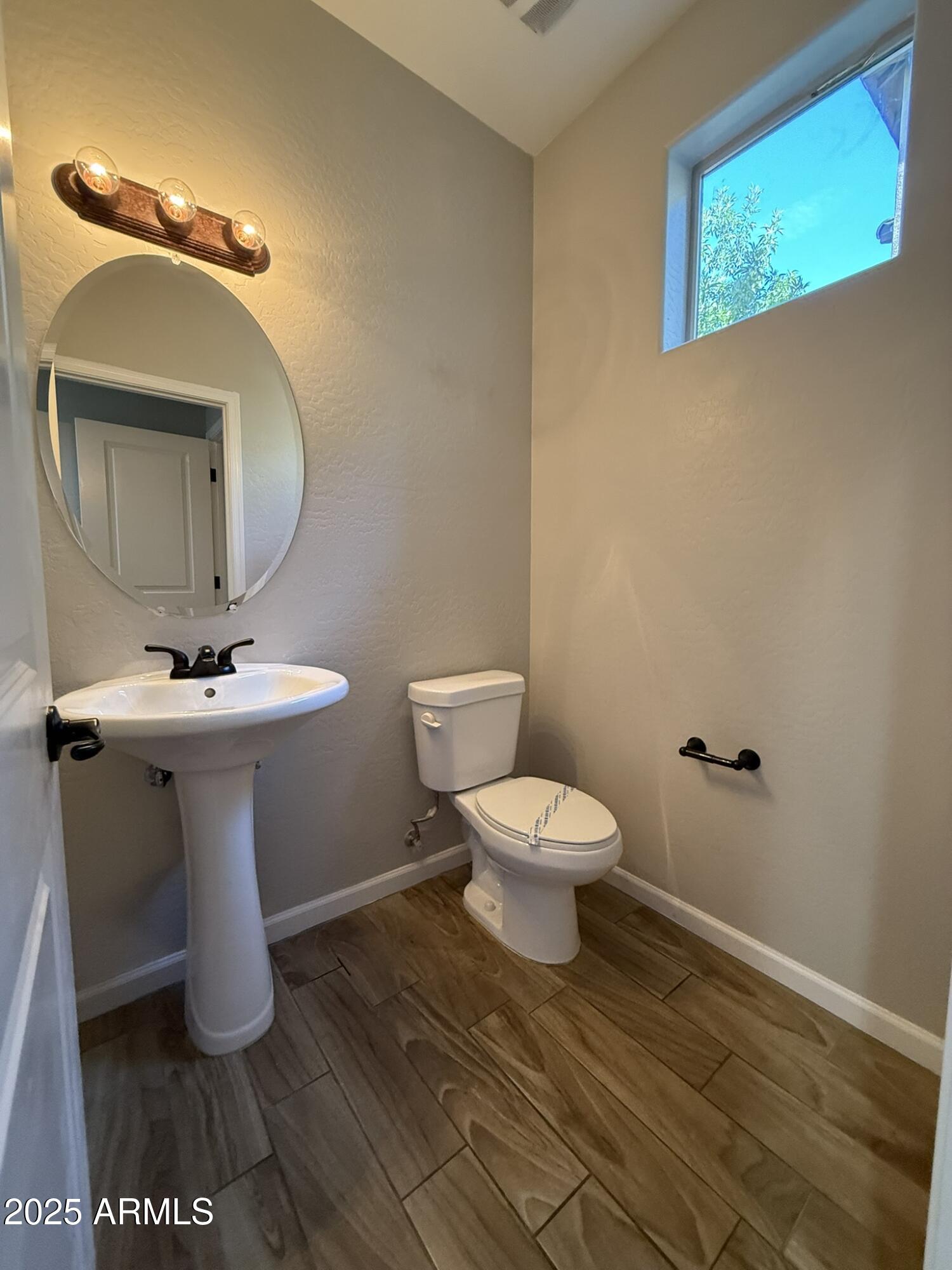 1736 West Pollack Street Phoenix, AZ 85041 - Photo 8 of 51 a bathroom with a toilet sink and mirror