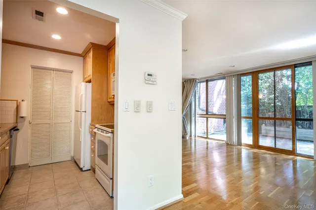 a view of a hallway with furniture and a livingroom