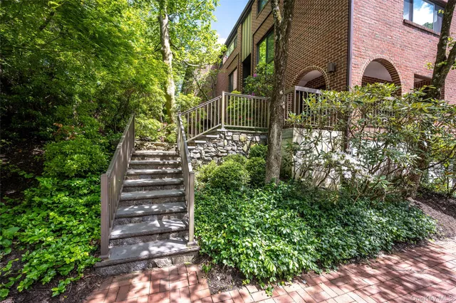 a view of front door of house with potted plants