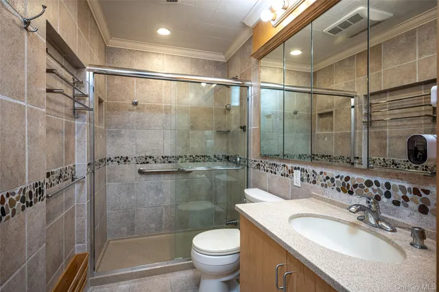 a bathroom with a sink vanity granite toilet and shower