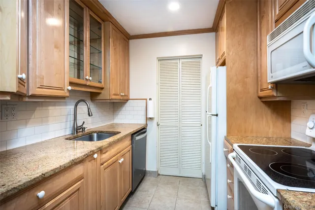 a kitchen with stainless steel appliances granite countertop a sink and a stove