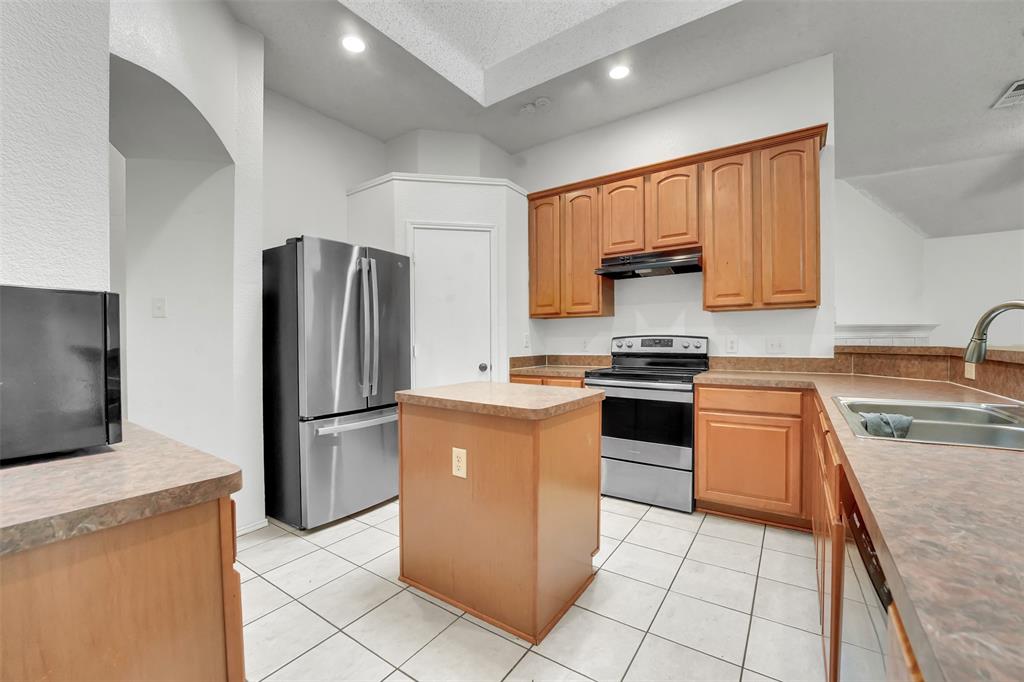 4507 Stones River Road Grand Prairie, TX 75052 - Photo 14 of 28 a kitchen with cabinets and stainless steel appliances