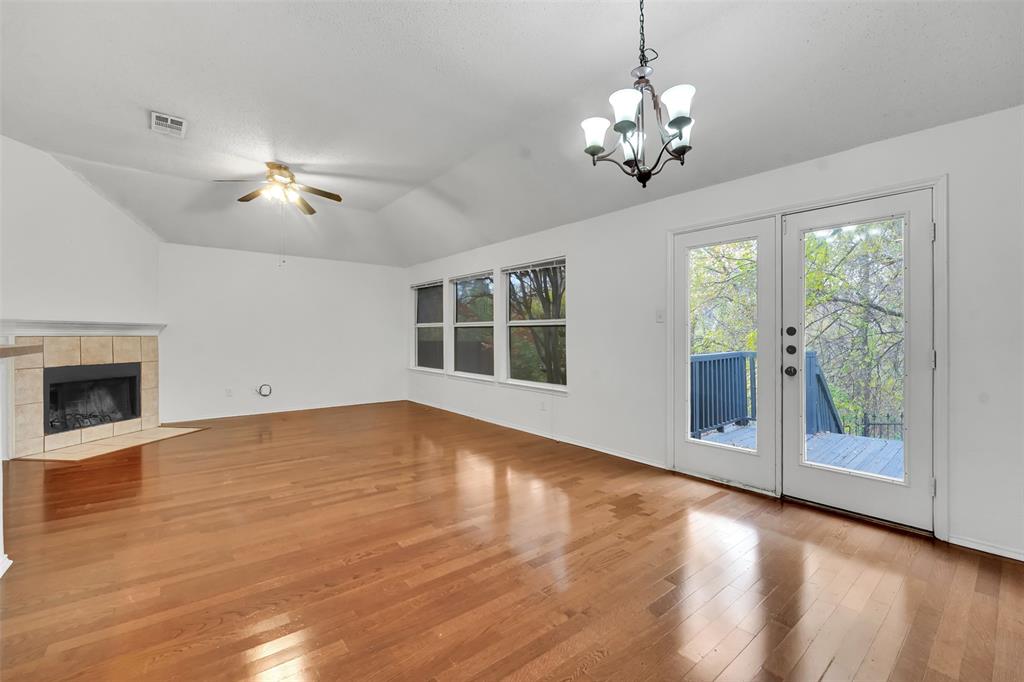 4507 Stones River Road Grand Prairie, TX 75052 - Photo 17 of 28 a view of an empty room with a window and wooden floor